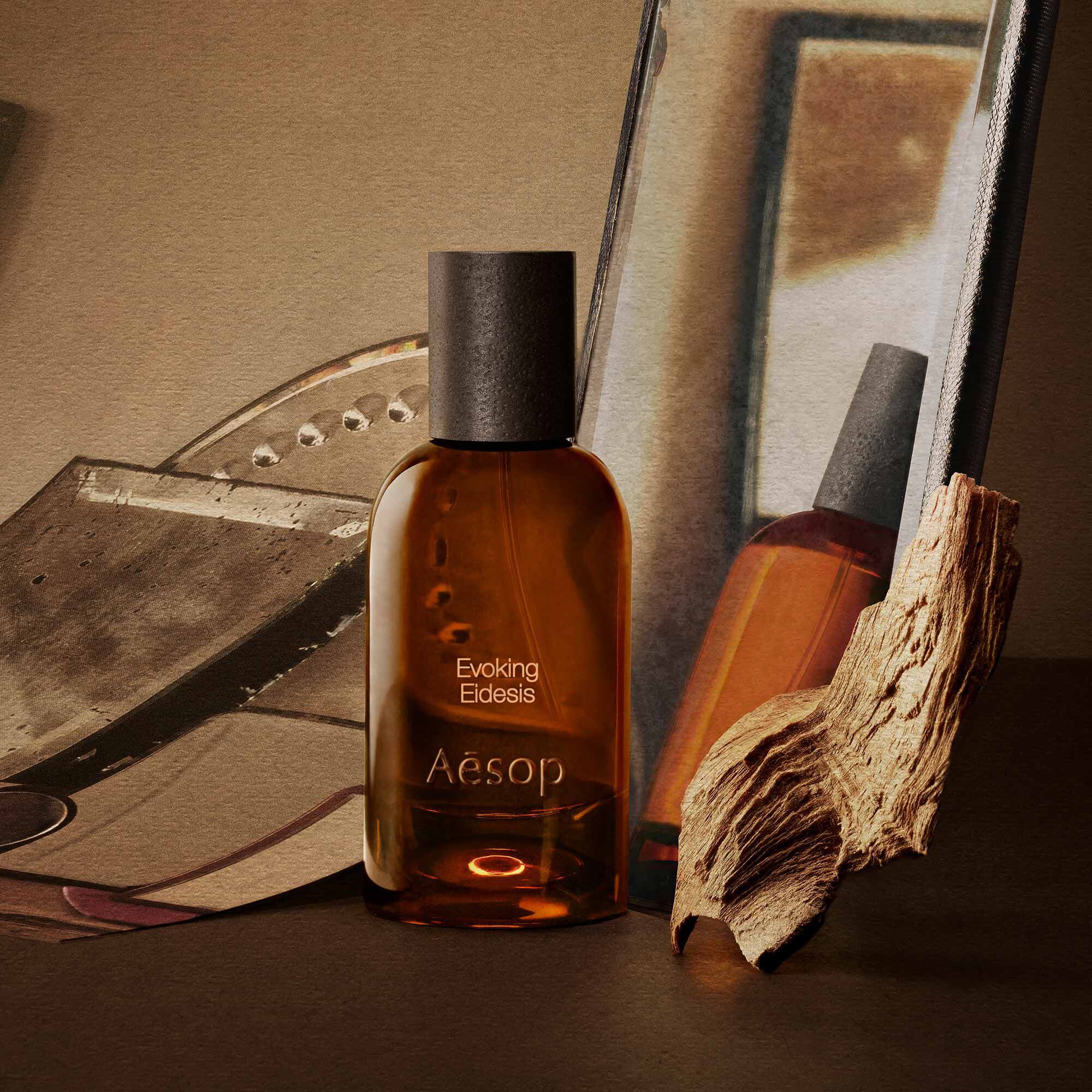 Aesop Evoking Eidesis bottle with a tube and piece of wood on mirrored trays.